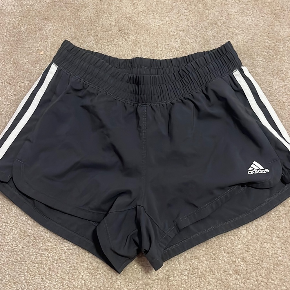 Dark grey athletic Adidas shorts.